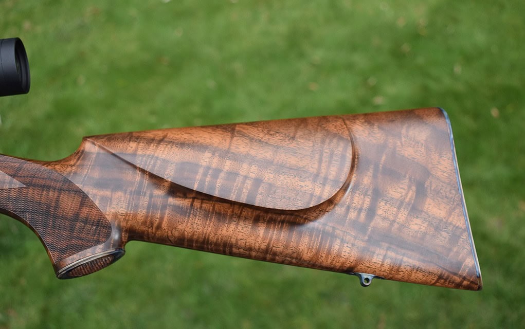 Several of the custom touches include a steel buttplate, skeleton grip cap, Howell swivels, and the cheekpiece and checkering.